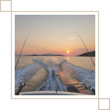 A picture of the sunset taken from a fishing boat on the ocean.